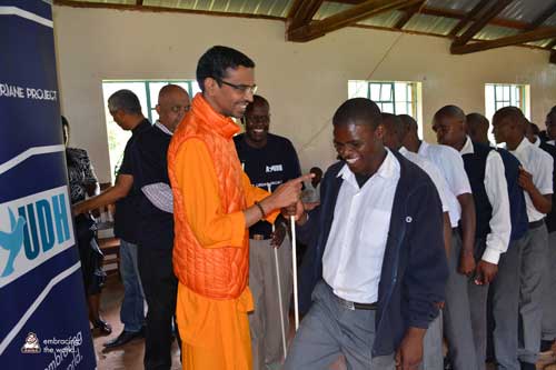 Swami Shubhamritananda greets African man
