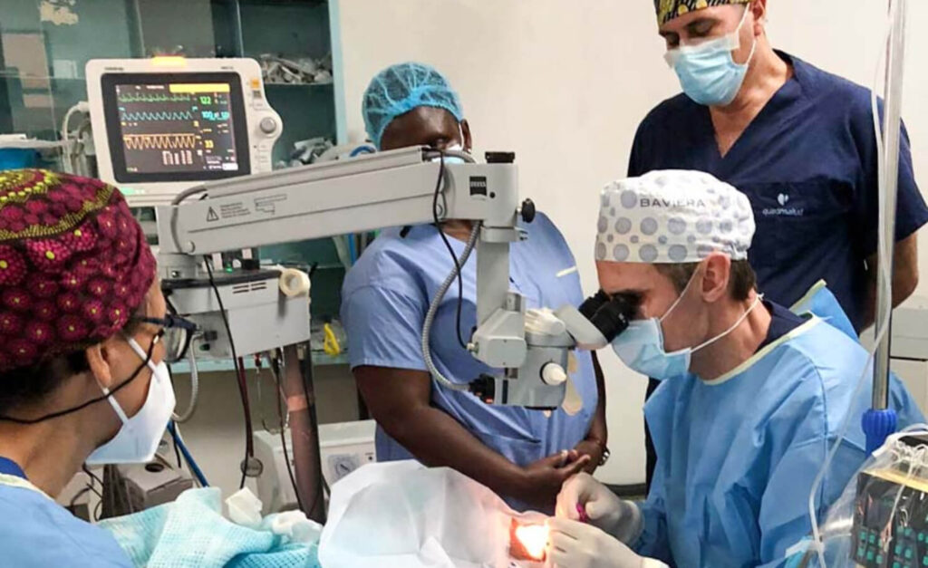 During Chairty's surgery, a medical team surround her as the doctor operates.