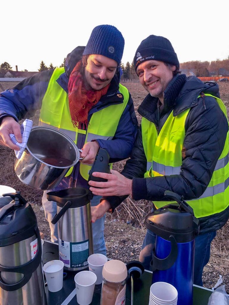 Volunteer peparing something hot to drink in the cold weather.