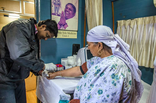 Medical staff helps a woman in a mobile vehicle
