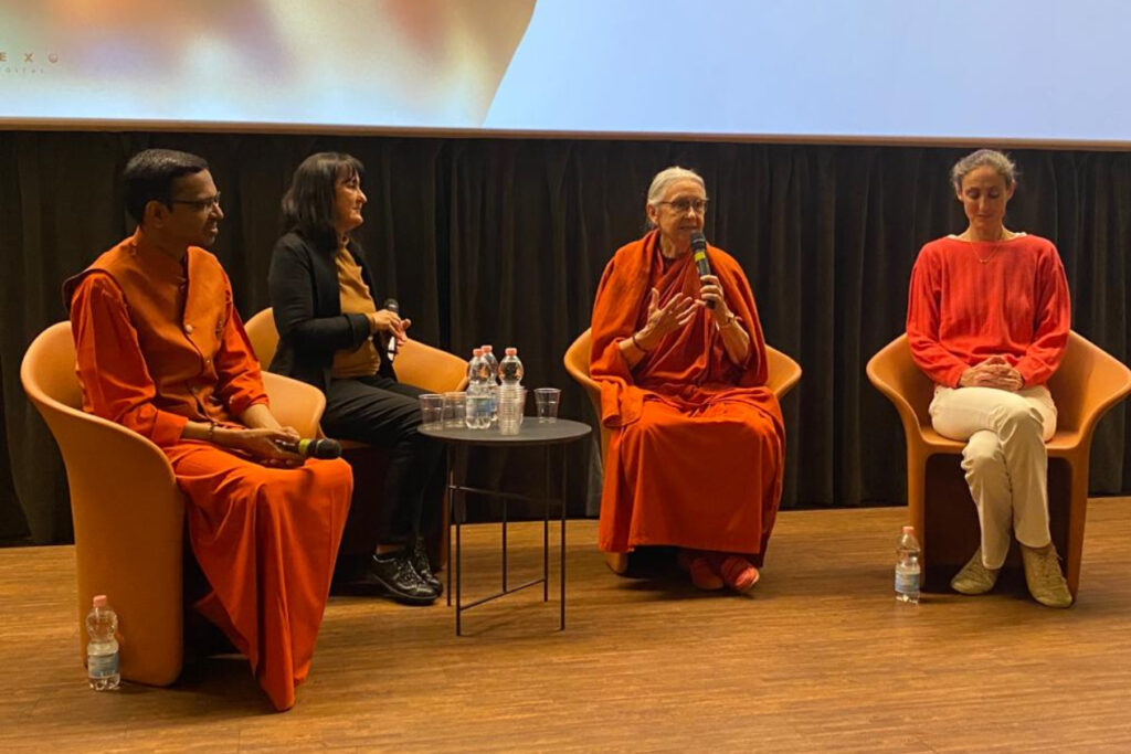 Swami Shubamritananda Puri, Manuela Ceresola with Amma Italia, Swamini Amritajyoti Prana, and filmmaker Anna Agnelli sitting on stage at the debut for the new documentary about Amma.