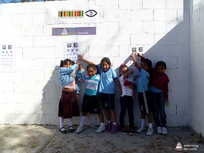 Mexican children stand and smile
