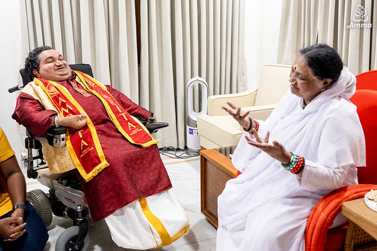Amma and a special guest speak