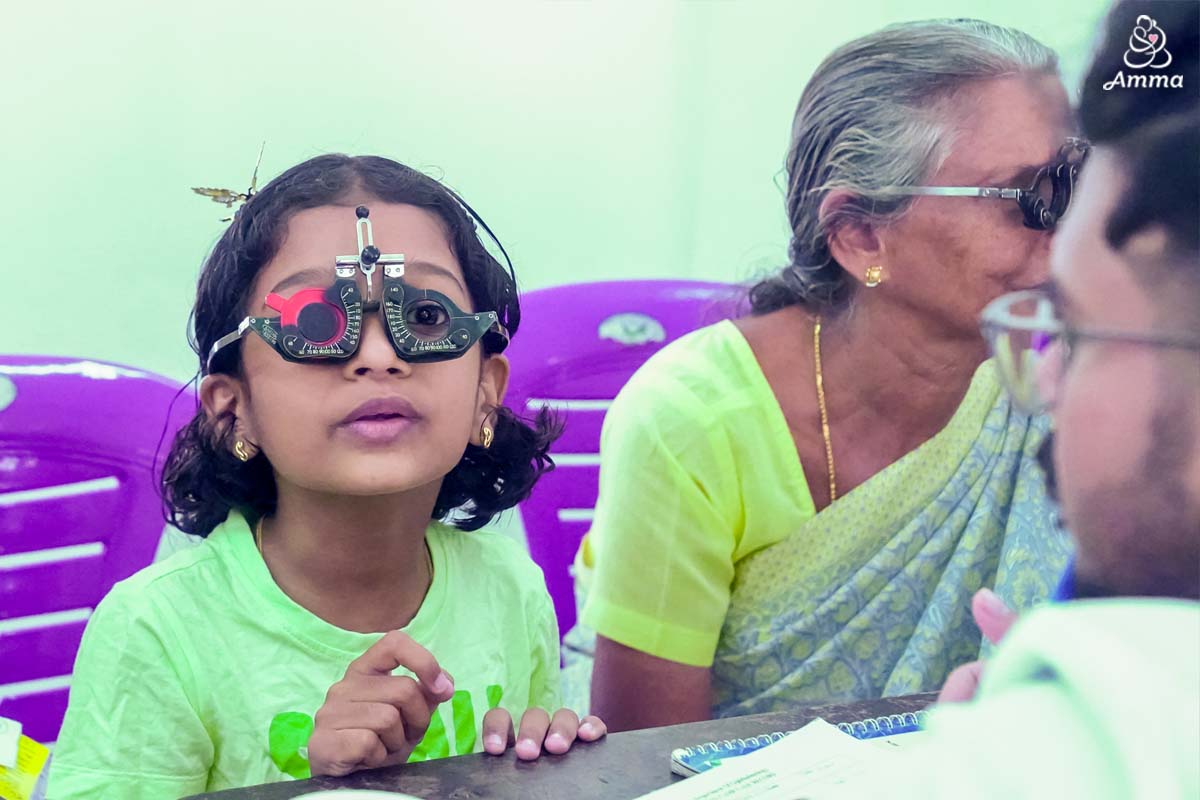 A little girl looks through equipment to test her vision
