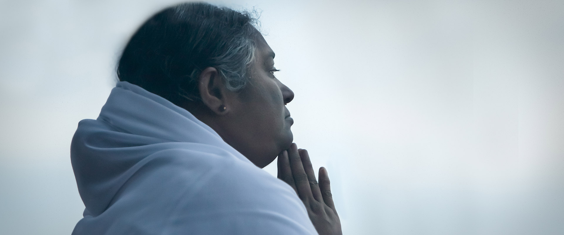 Amma with her hands in prayer
