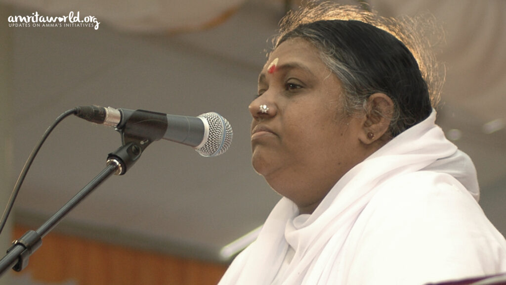 Amma speaks into a microphone