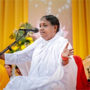 Amma in front of microphone giving a talk