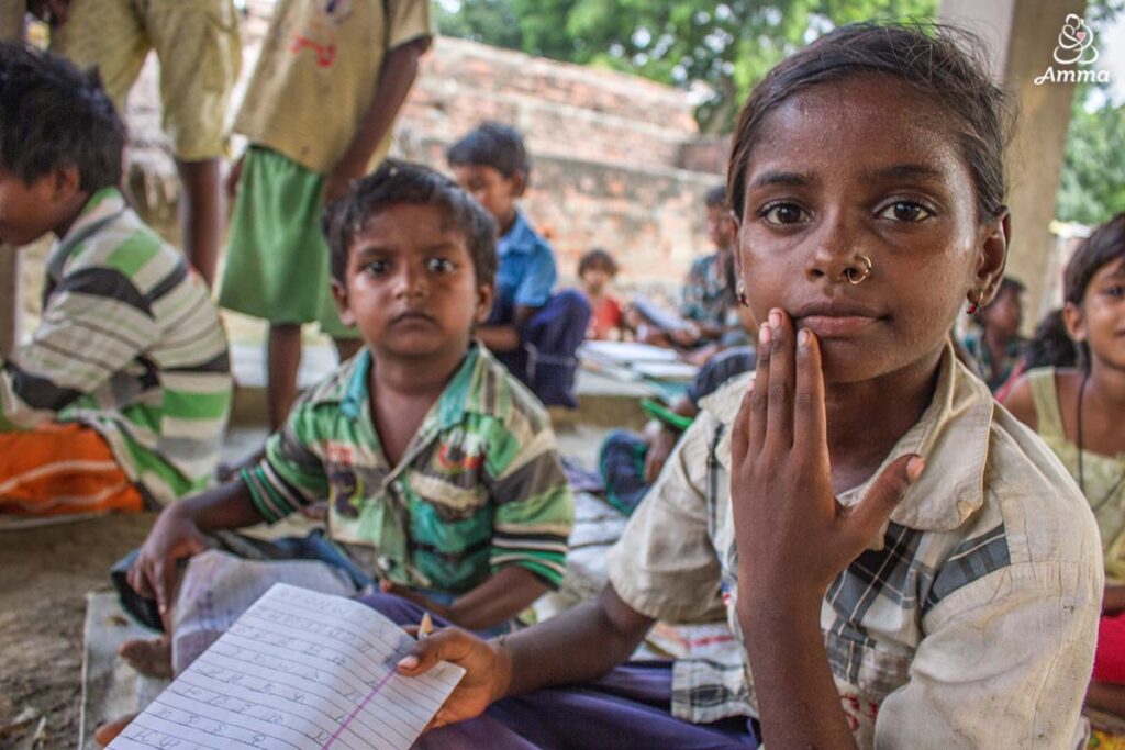 a girl looks at the camera holding her notebook