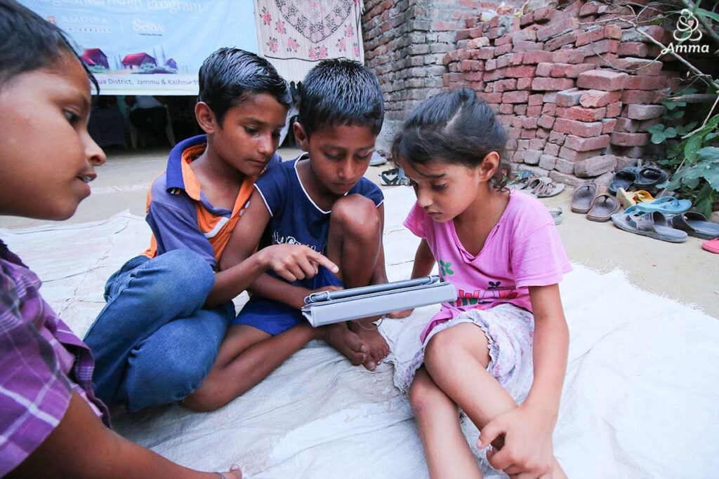 three children engage with a tablet