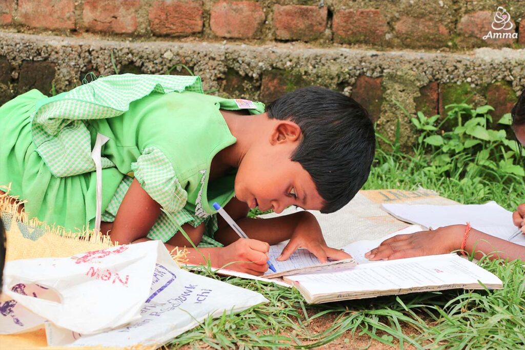 A small girl writes in a notebook
