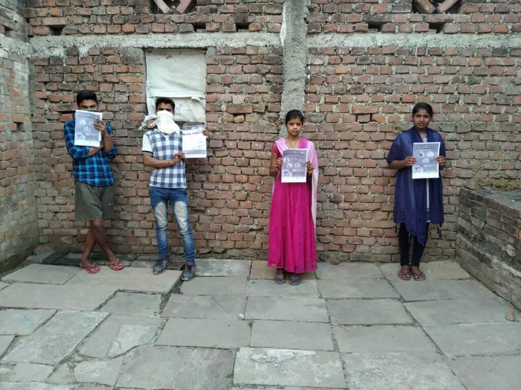 Students hold up posters