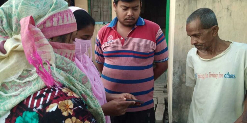 Villagers watch video on phone