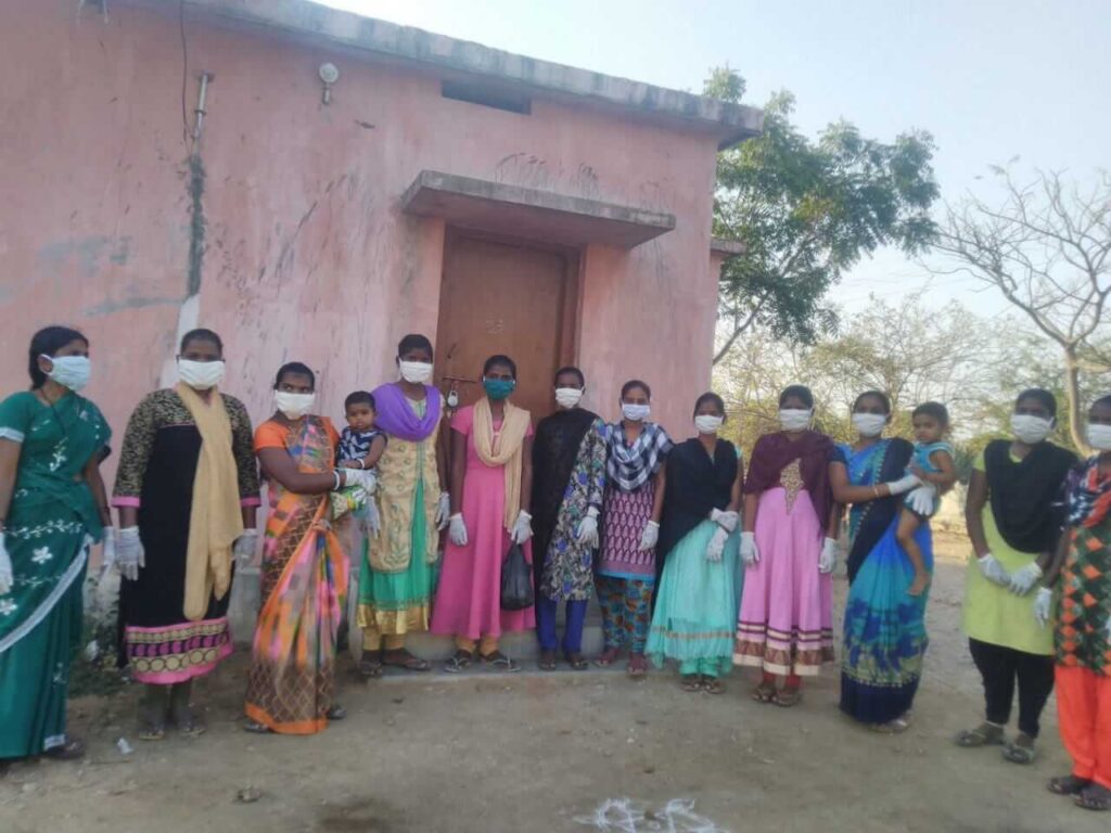 Villagers stand with new masks