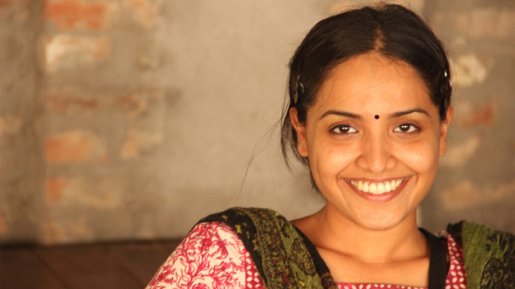 Woman recipient of aid smiles into camera