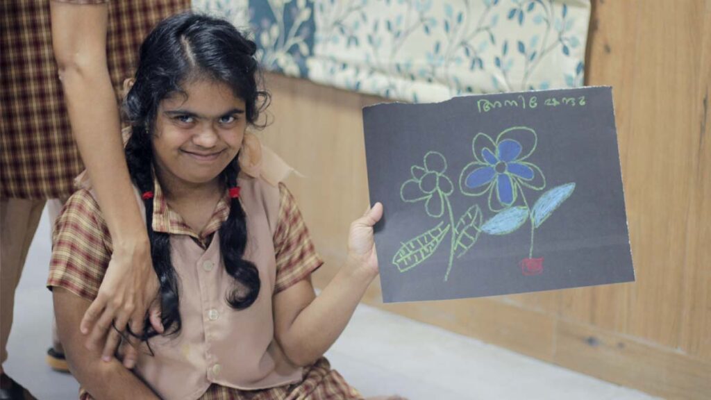 Girl with Down Syndrome shows her drawing