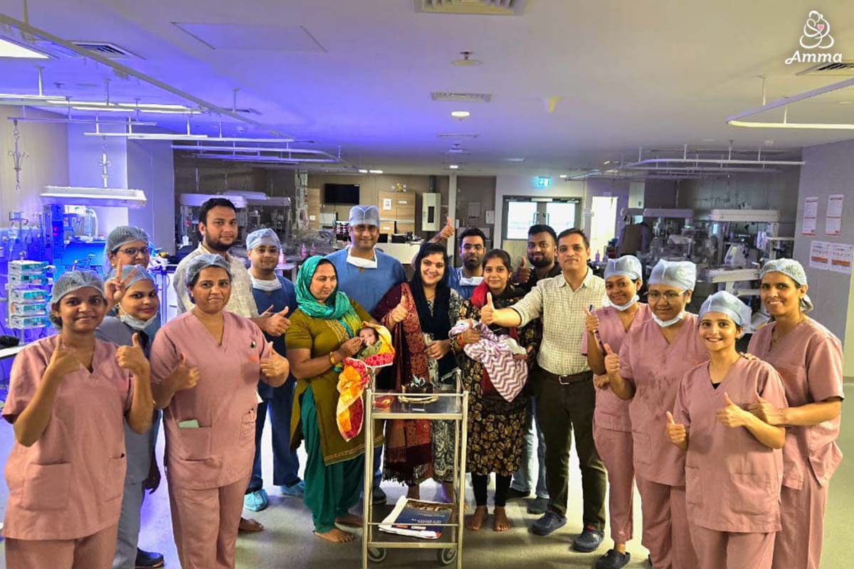 medical team with parents holding babies