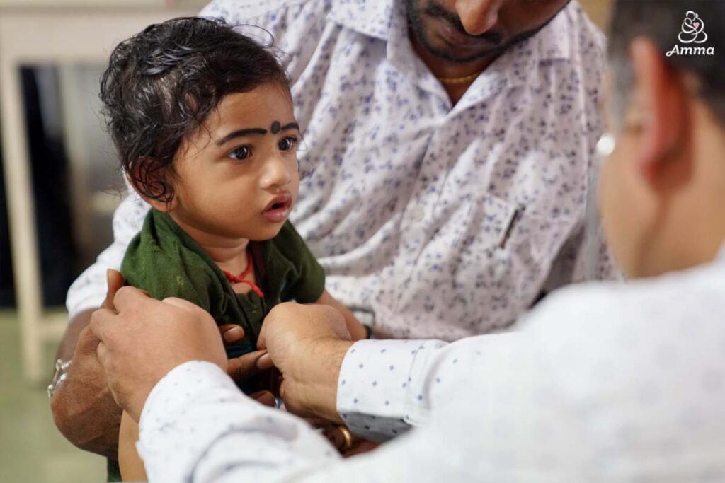 a doctor measures a child's heartbeat