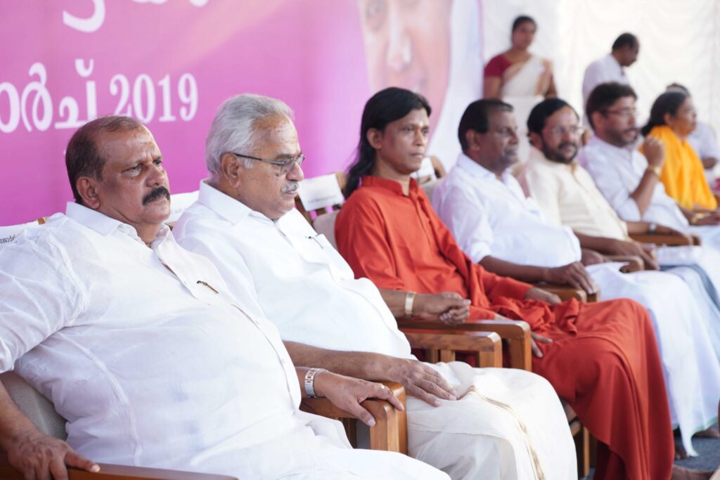 Dignitaries and swami listen to talks