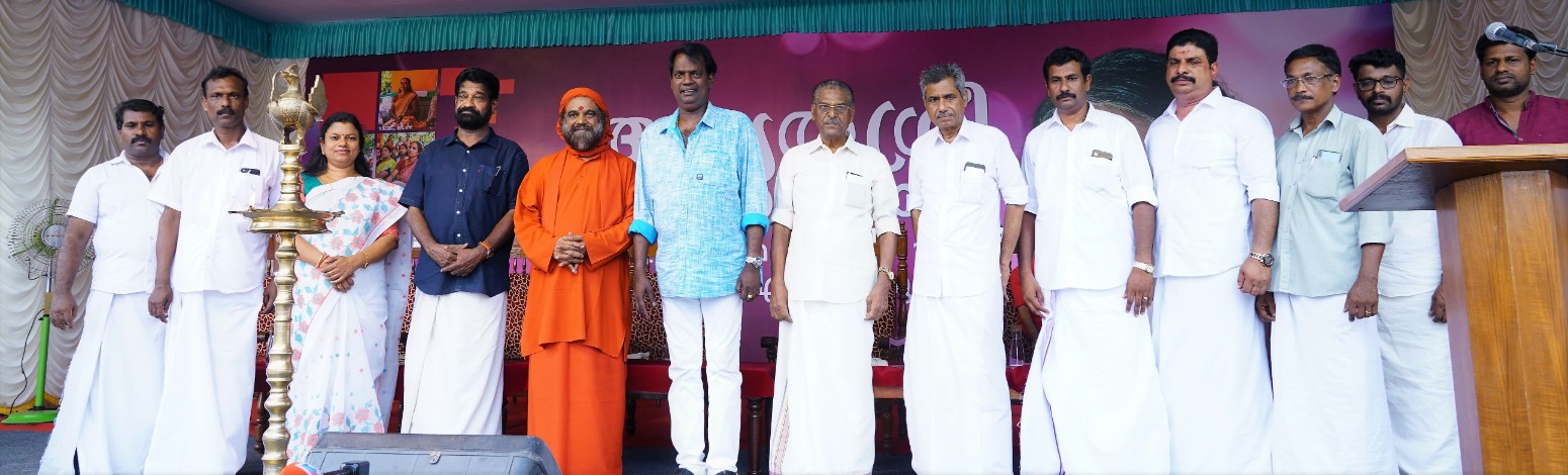 Dignitaries and swami stand on stage