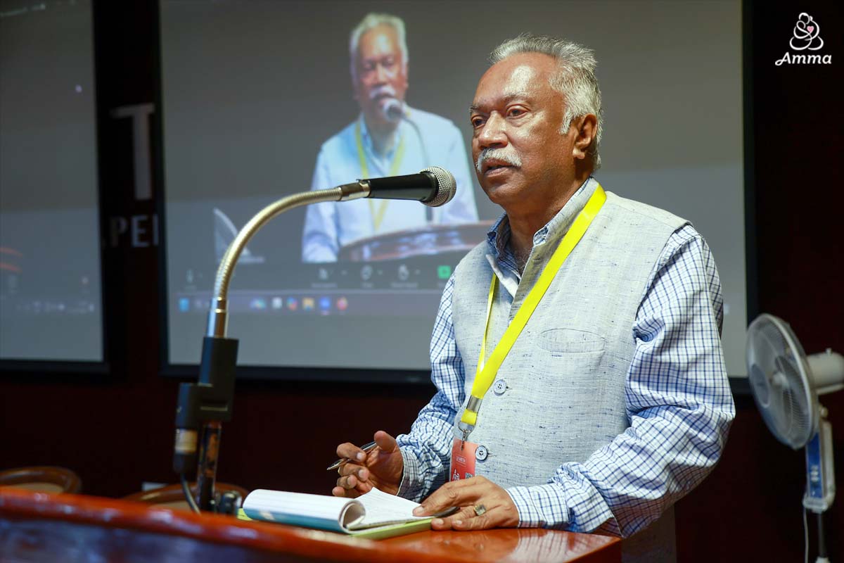 A man speaks at a microphone