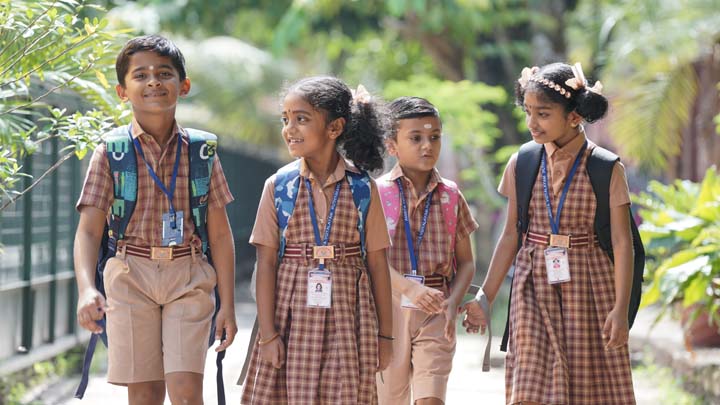 children in school uniforms walking