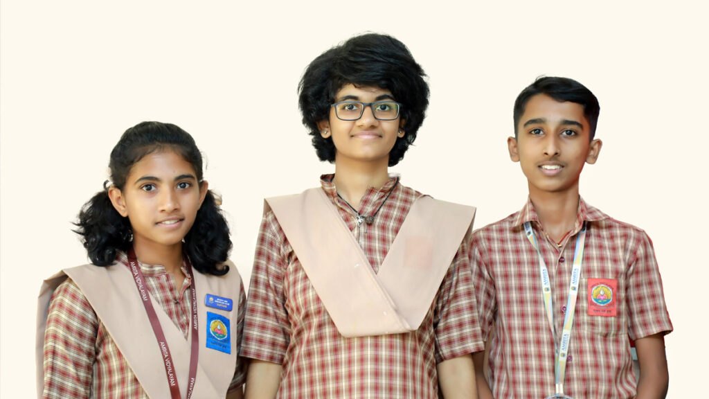 The three students who were honoured smile