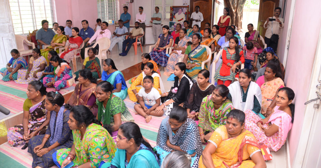 A group of children and volunteers sit together