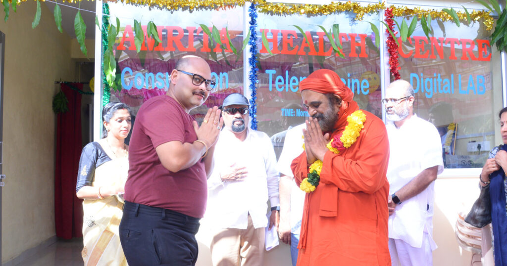 Dr. Sandeep Roy and Swami Purnamritananda Puri greet each other