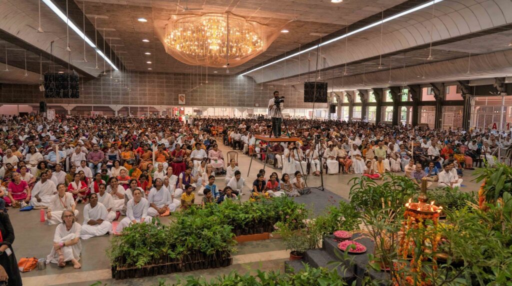 The Amritapuri hall is full of people and plants