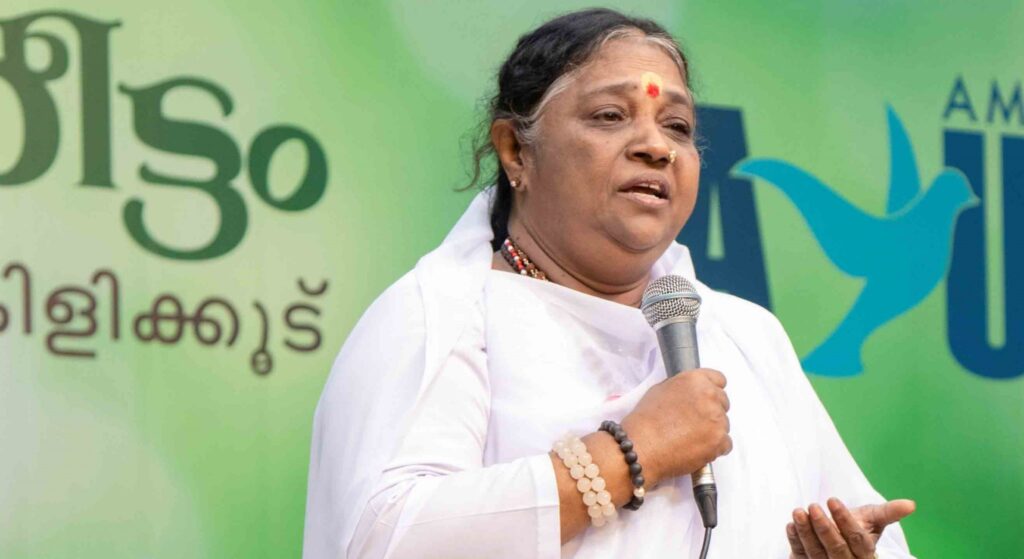 Amma speaks into a microphone