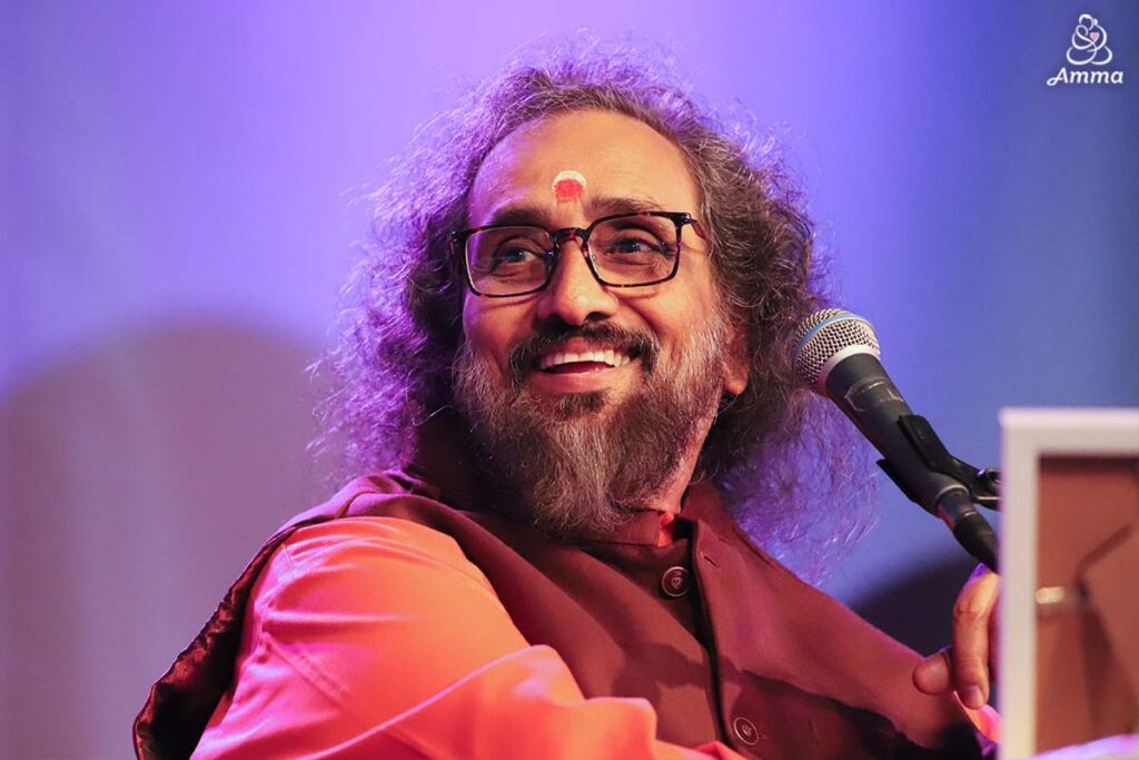 A swami at a microphone
