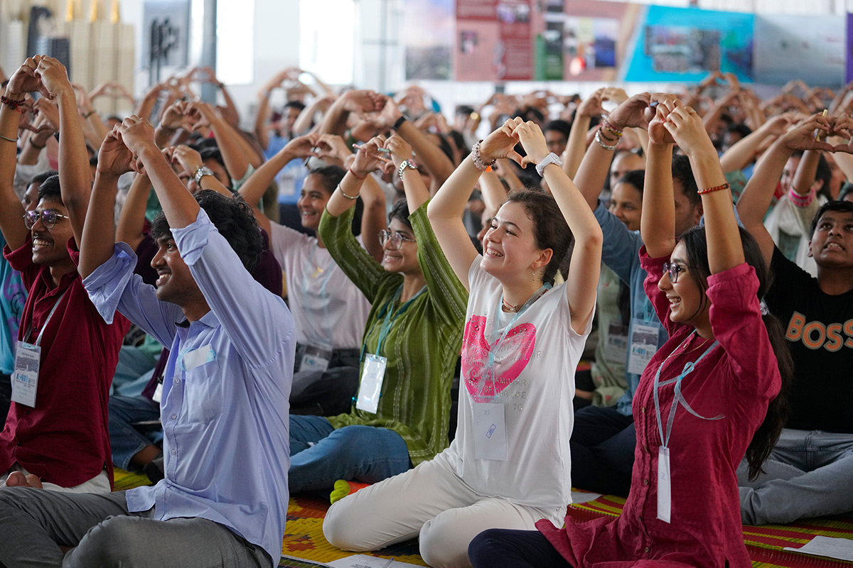 youth make a heart shape with their hands