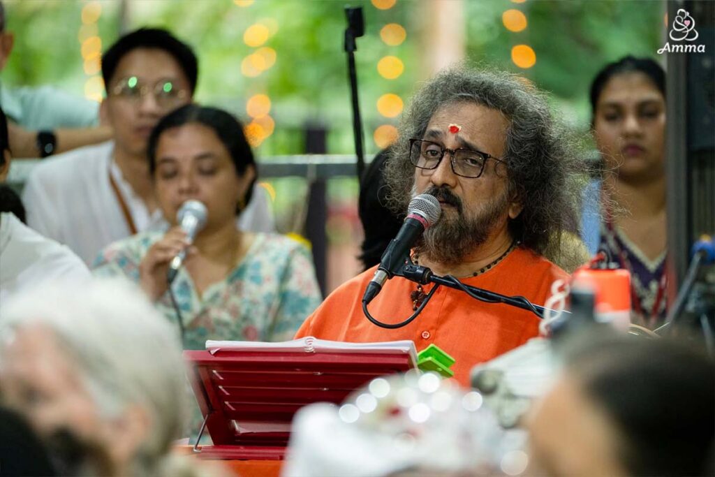Swamiji sings to Amma