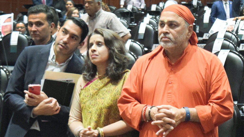 Ms. Shruti Shukla, Indian Embassy of Mexico, in a lovely green sari, with her colleague, listen sincerely with Swami Dayamritananda Puri.