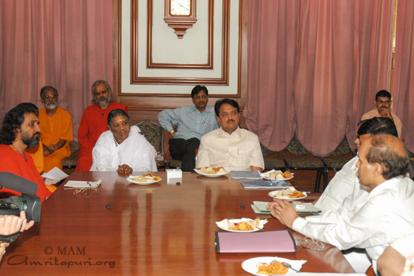 Amma at a meeting with dignitaries