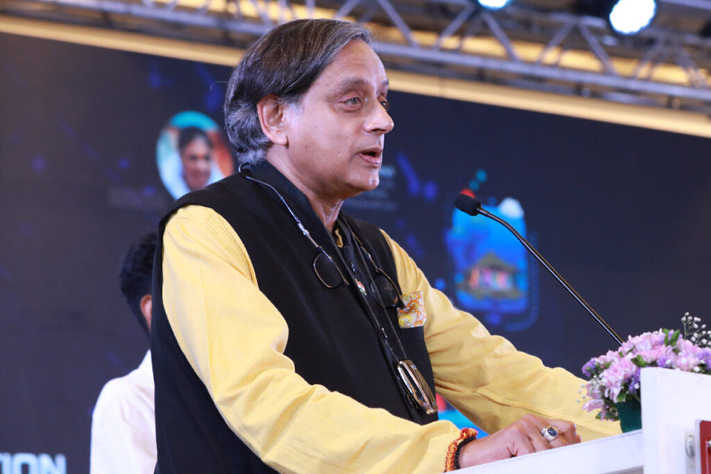 Dr Shashi Tharoor in a profile, with a black vest and yellow shirt, defines education to include digital literacy for children, especially in rural areas.