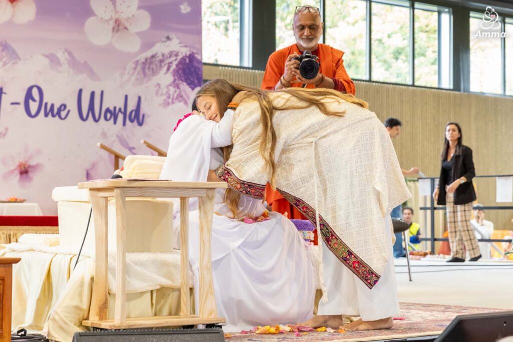 Amma gives darshan to a young woman