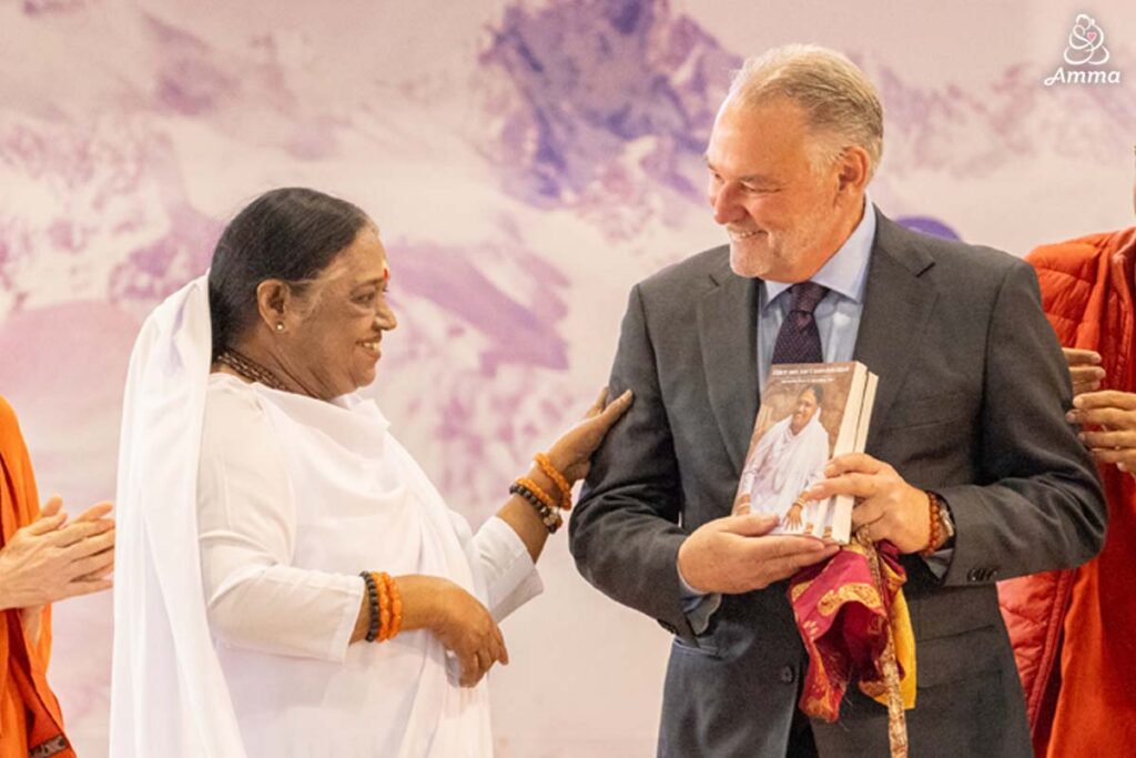 Amma with a man holding a book