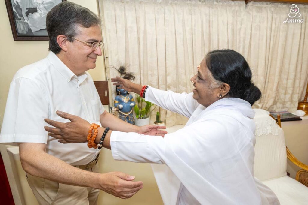 Amma embraces the French Ambassador to India