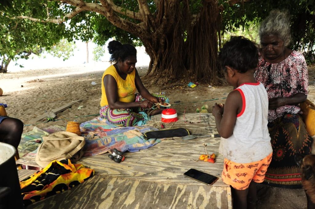 Women working on traditional weaving