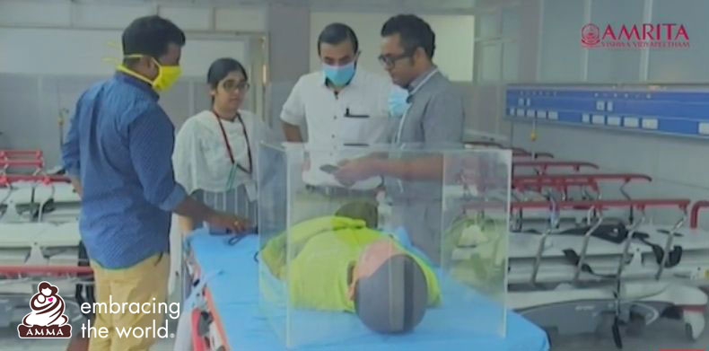 Doctors stand around a model intubation box