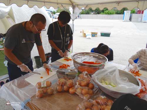 Volunteers chop carrots