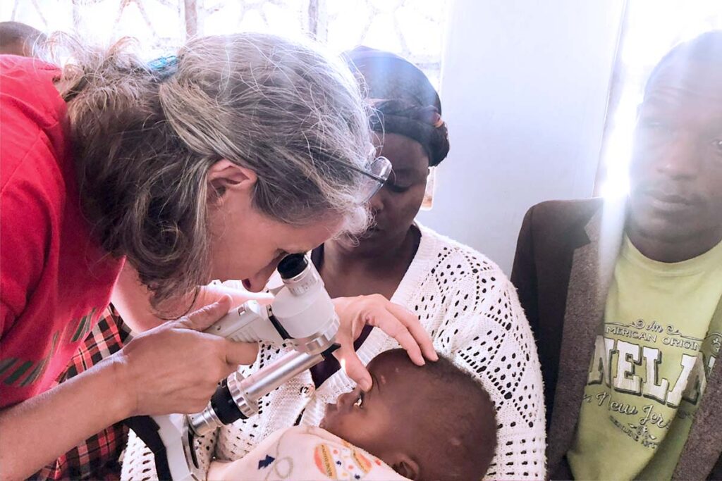 a doctor examines a baby's eye