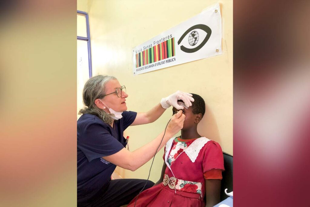 An eye doctor examines a little girl