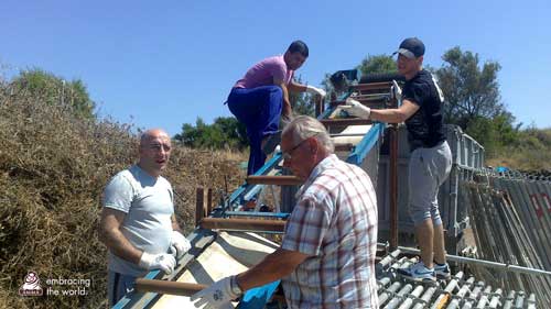 Volunteers build a roof