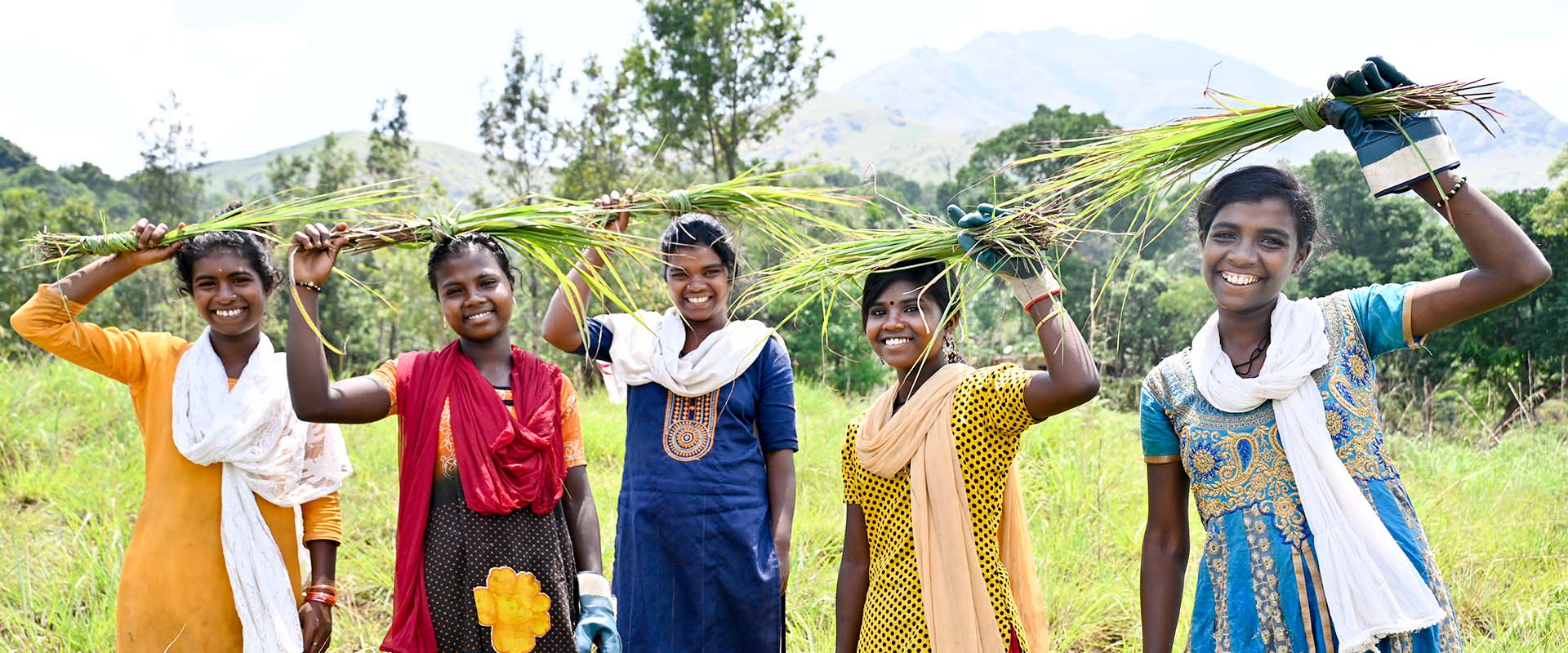 young women holding bundles of lemongrass