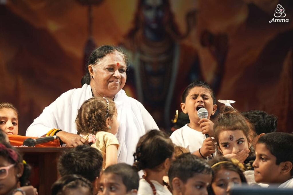 Amma with a child singing passionately into the microphone