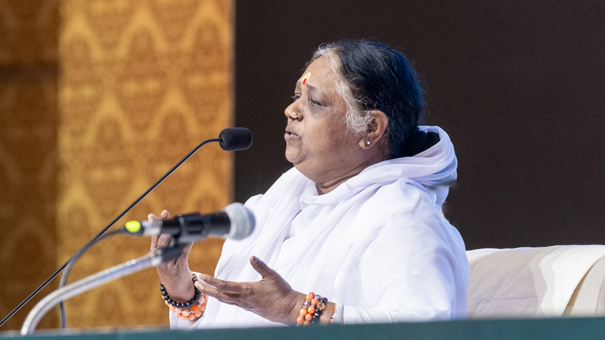Amma speaks at the microphone