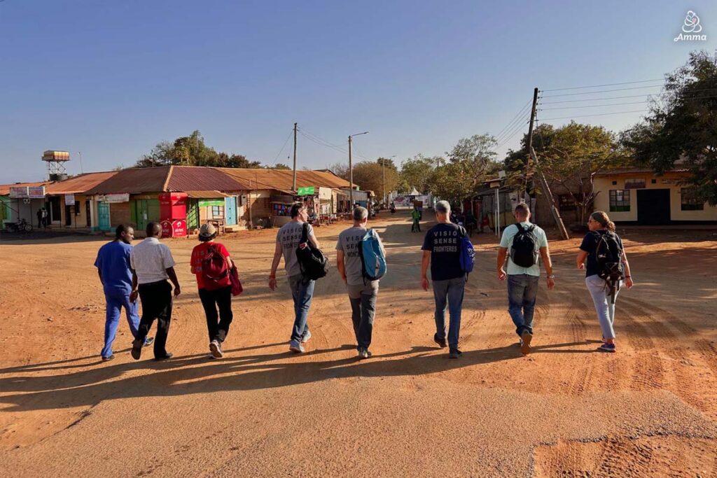 A group of people walk in sunset