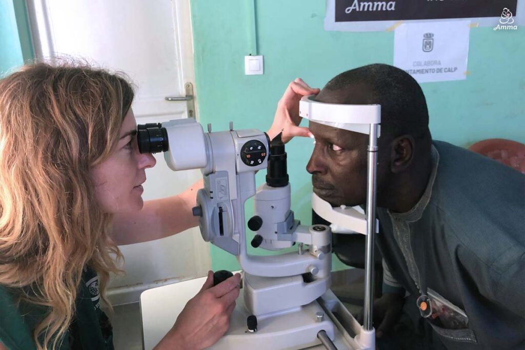 An optometrist scans a man's eyes